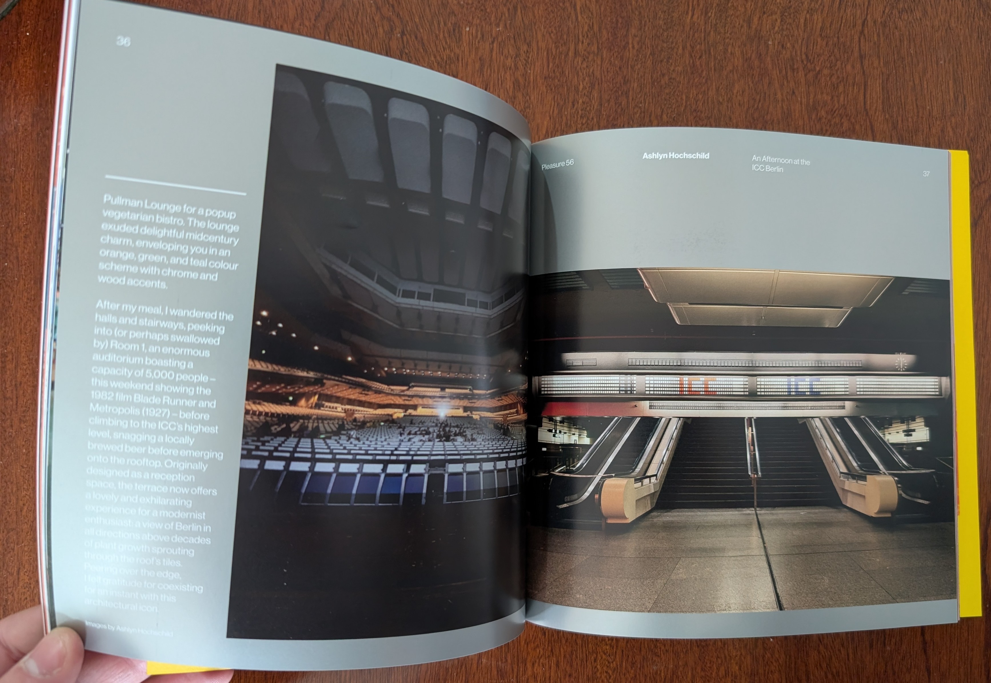 A zine being held open, with photos of the ICC interior in the background