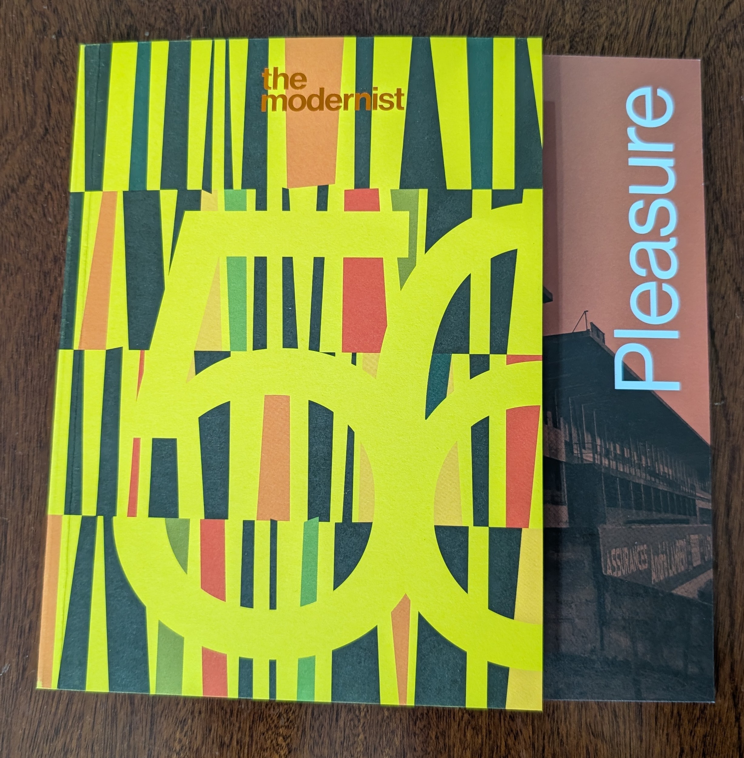 Front cover of the Modernist - a yellow abstract art piece with 56 stenciled and "Pleasure"
