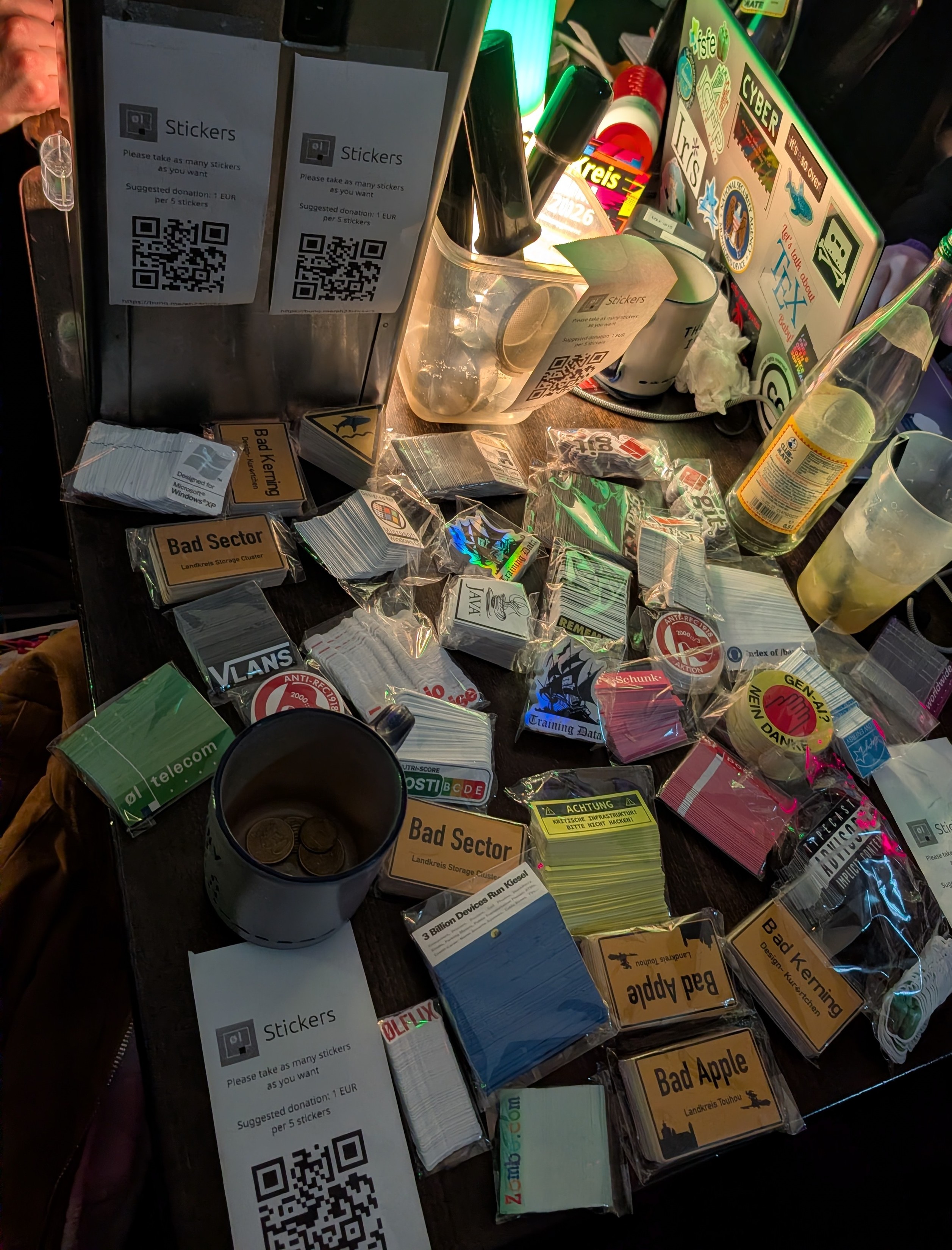A load of stickers laid on a busy table.