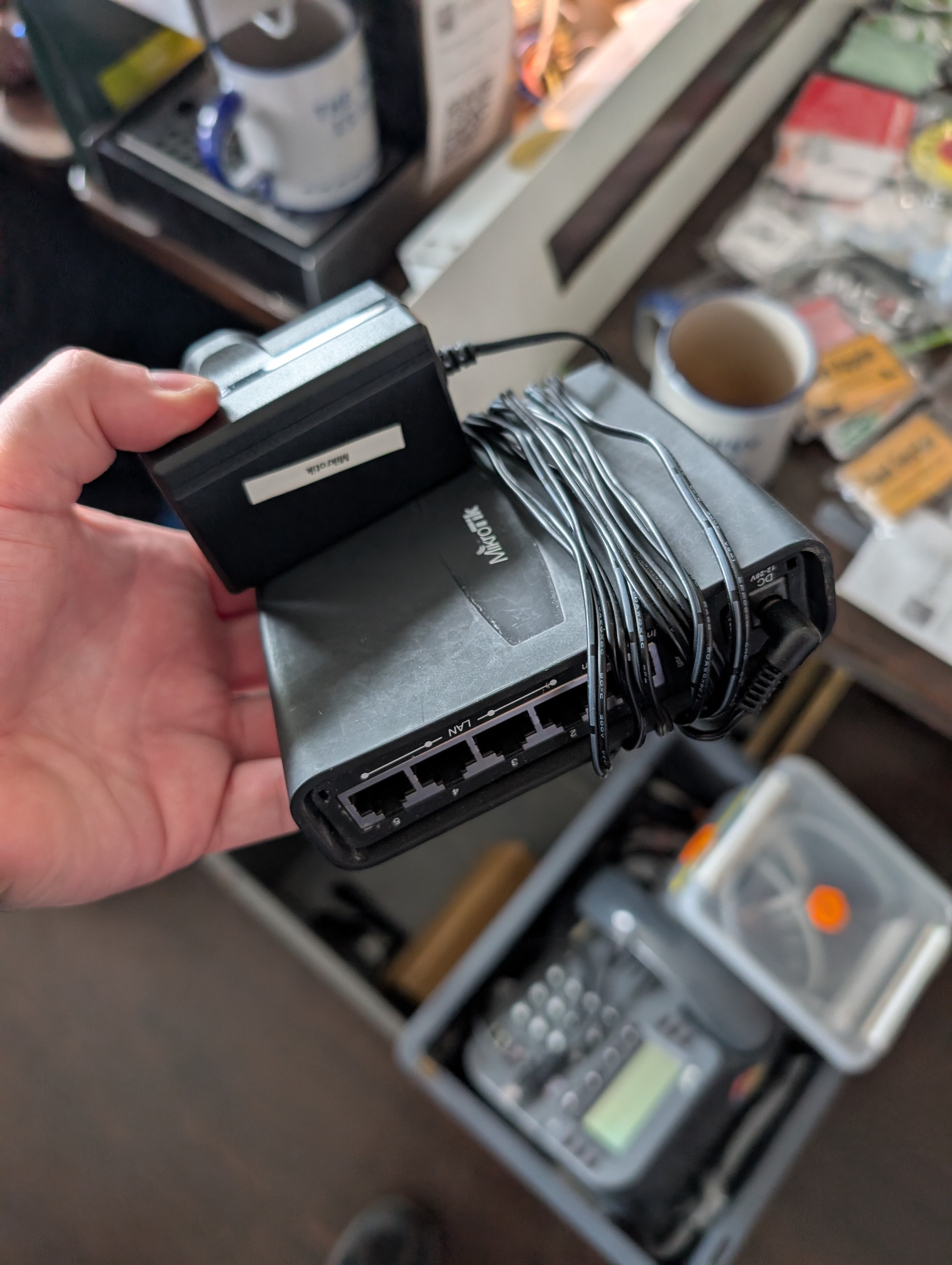 A hand holding a MicroTik